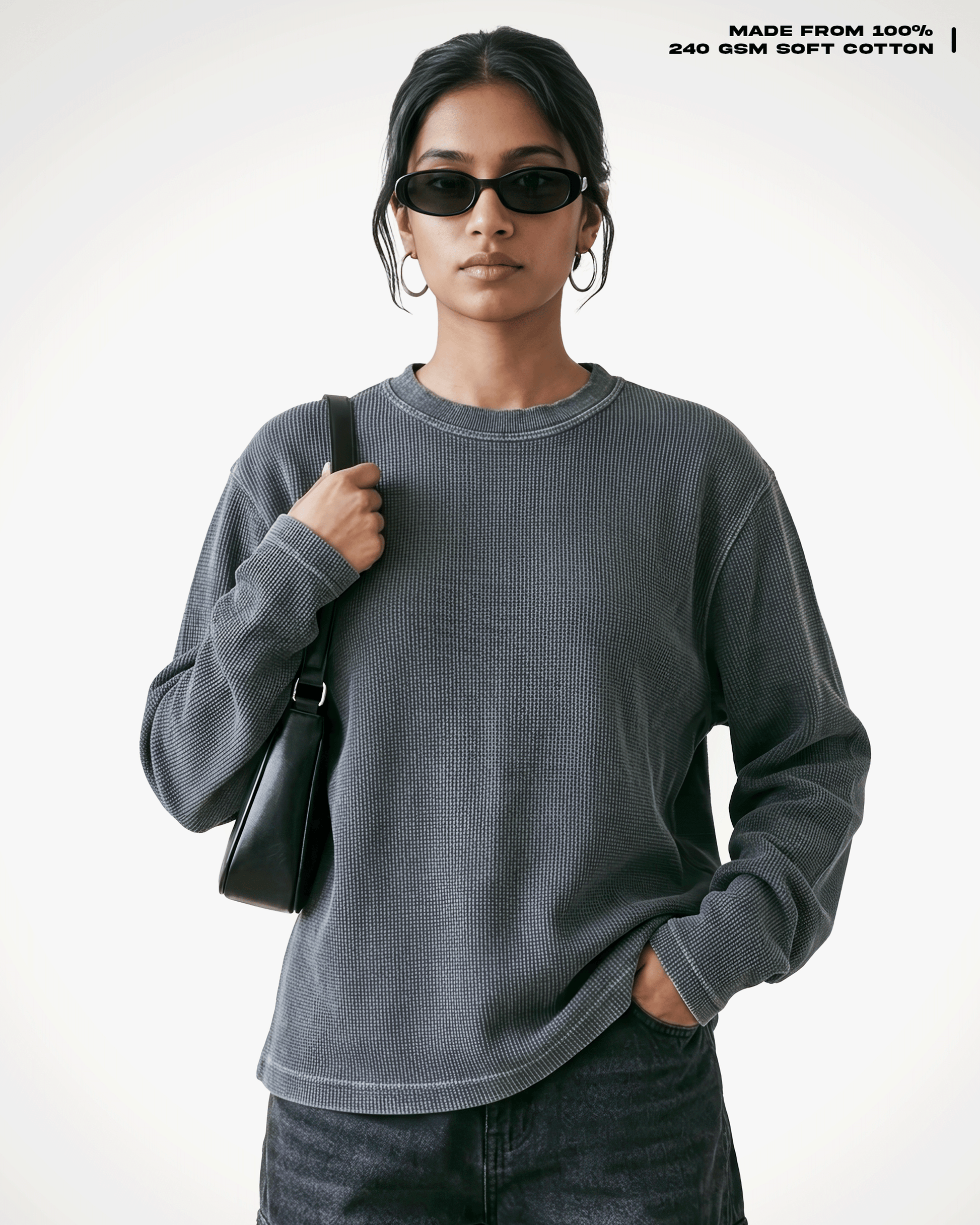 A model wearing a Acid Wash Full Sleeve Waffle Knit T-shirt Covert crewneck t-shirt, styled with black sunglasses, a black shoulder bag, and dark jeans against a clean white background. Text in the top right corner reads 'MADE FROM 100% 240 GSM SOFT COTTON'.