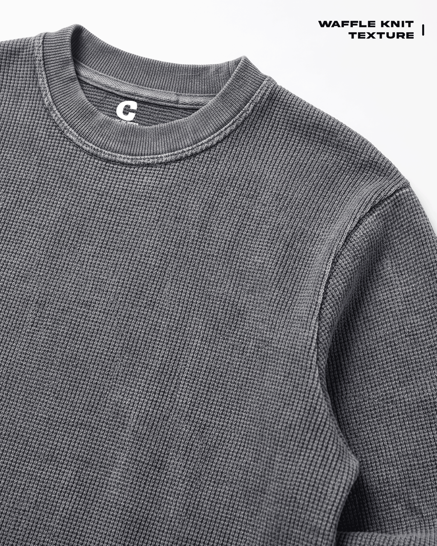 Close-up of a Acid Wash Full Sleeve Waffle Knit T-shirt Covert, highlighting the textured fabric and ribbed collar, with a small white 'C' logo on the inside neck tag. Text in the top right corner reads 'WAFFLE KNIT TEXTURE'.