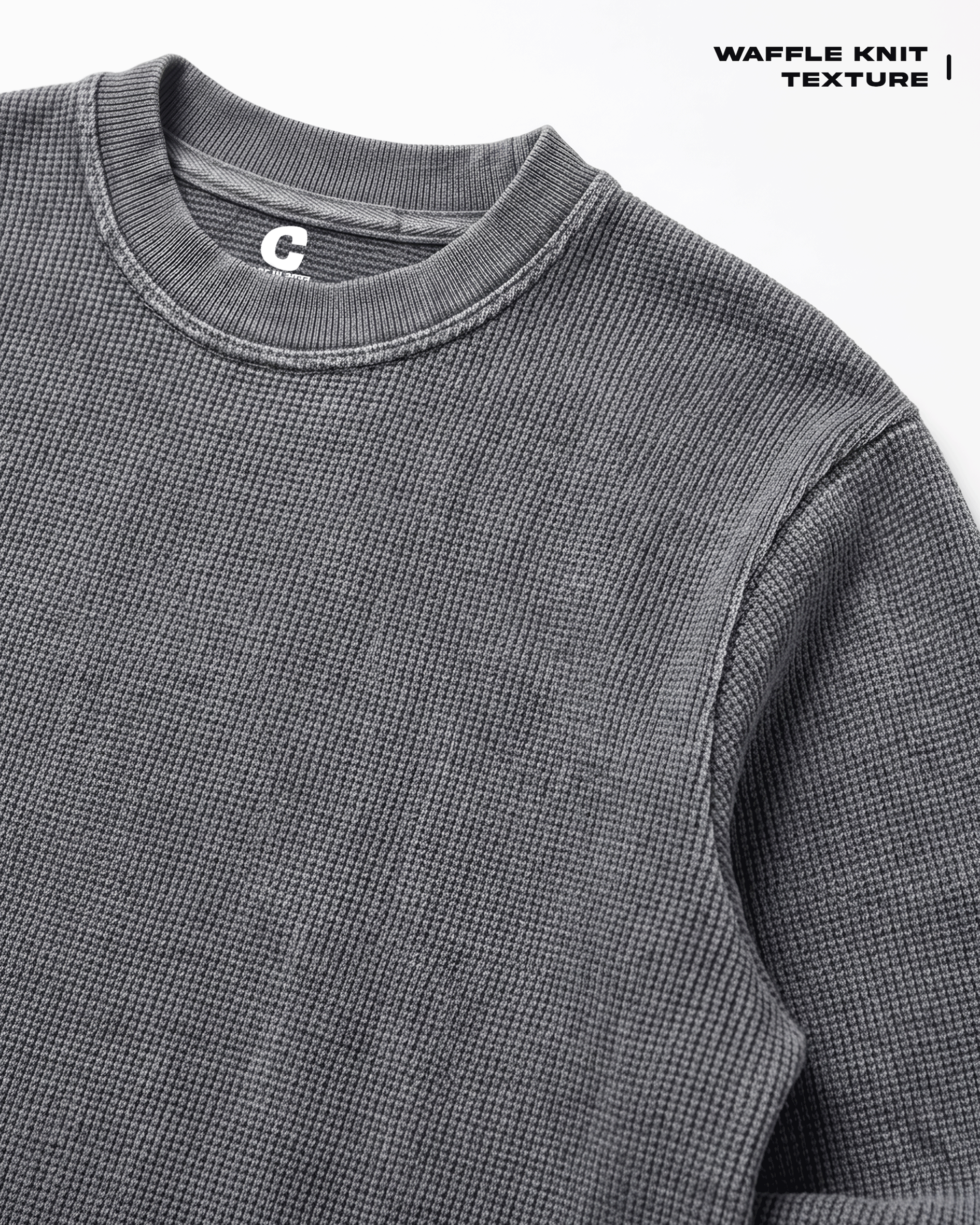 Close-up of a Acid Wash Full Sleeve Waffle Knit T-shirt Covert, highlighting the textured fabric and ribbed collar, with a small white 'C' logo on the inside neck tag. Text in the top right corner reads 'WAFFLE KNIT TEXTURE'.