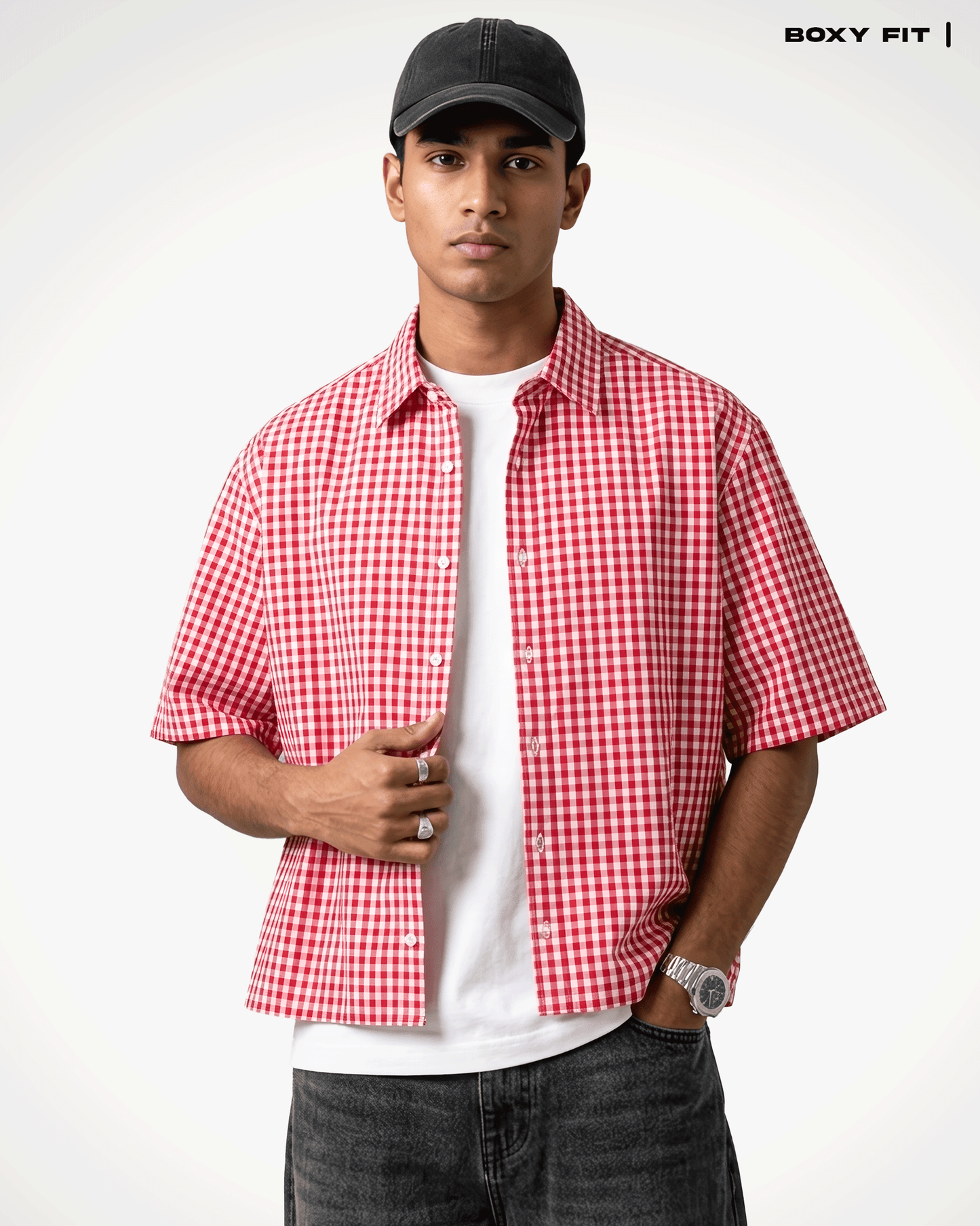A man wearing a Red Madras Check Shirt boxy fit shirt by Covert over a white t-shirt, paired with dark gray jeans and a black baseball cap. The text 'BOXY FIT |' is visible in the top right corner.