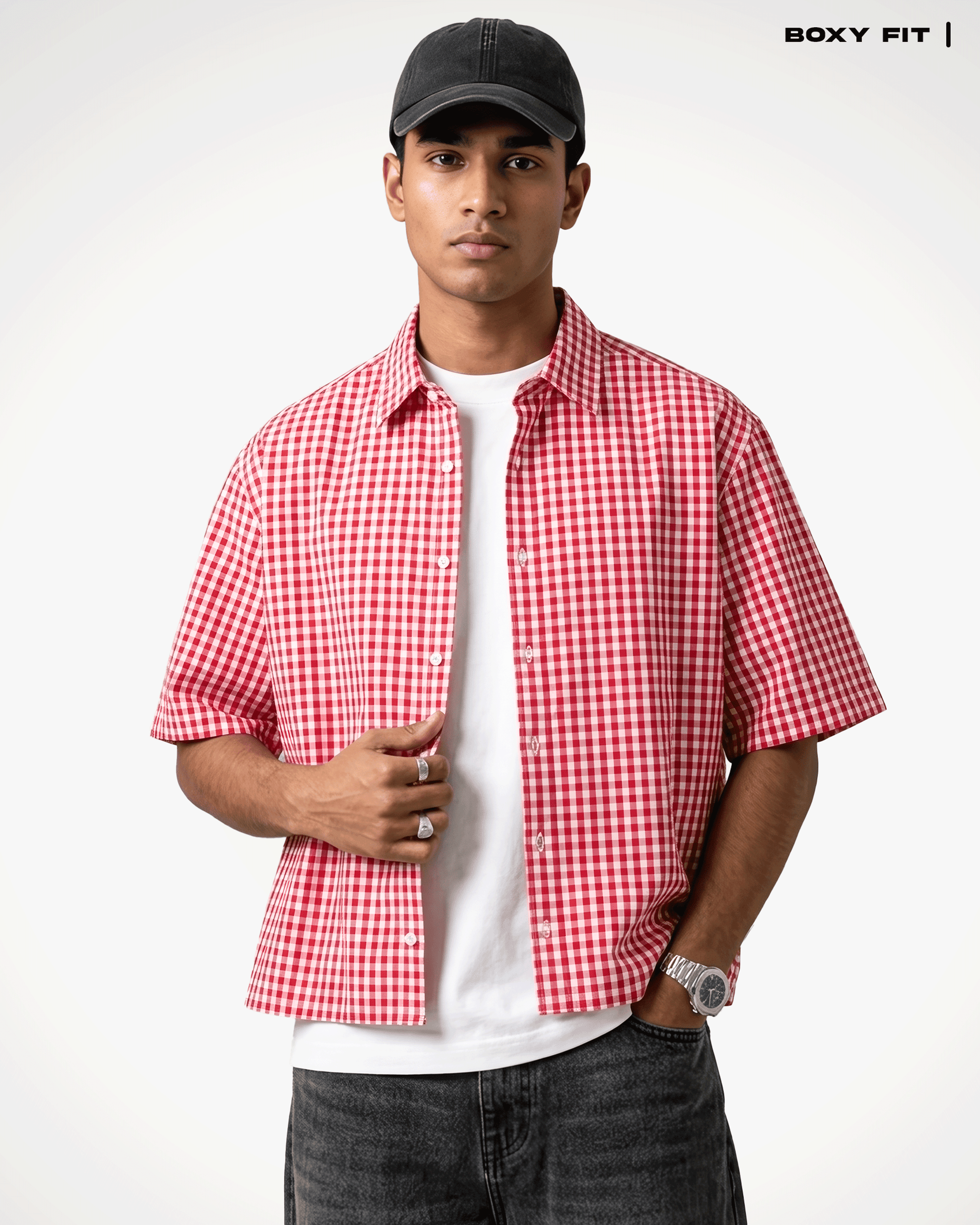 A man wearing a Red Madras Check Shirt boxy fit shirt by Covert over a white t-shirt, paired with dark gray jeans and a black baseball cap. The text 'BOXY FIT |' is visible in the top right corner.
