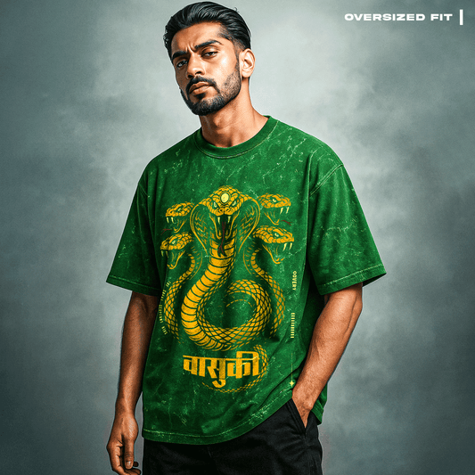 Man wearing a green t-shirt with a snake design on a gray background. Vasuki: The Serpent King T-Shirt
