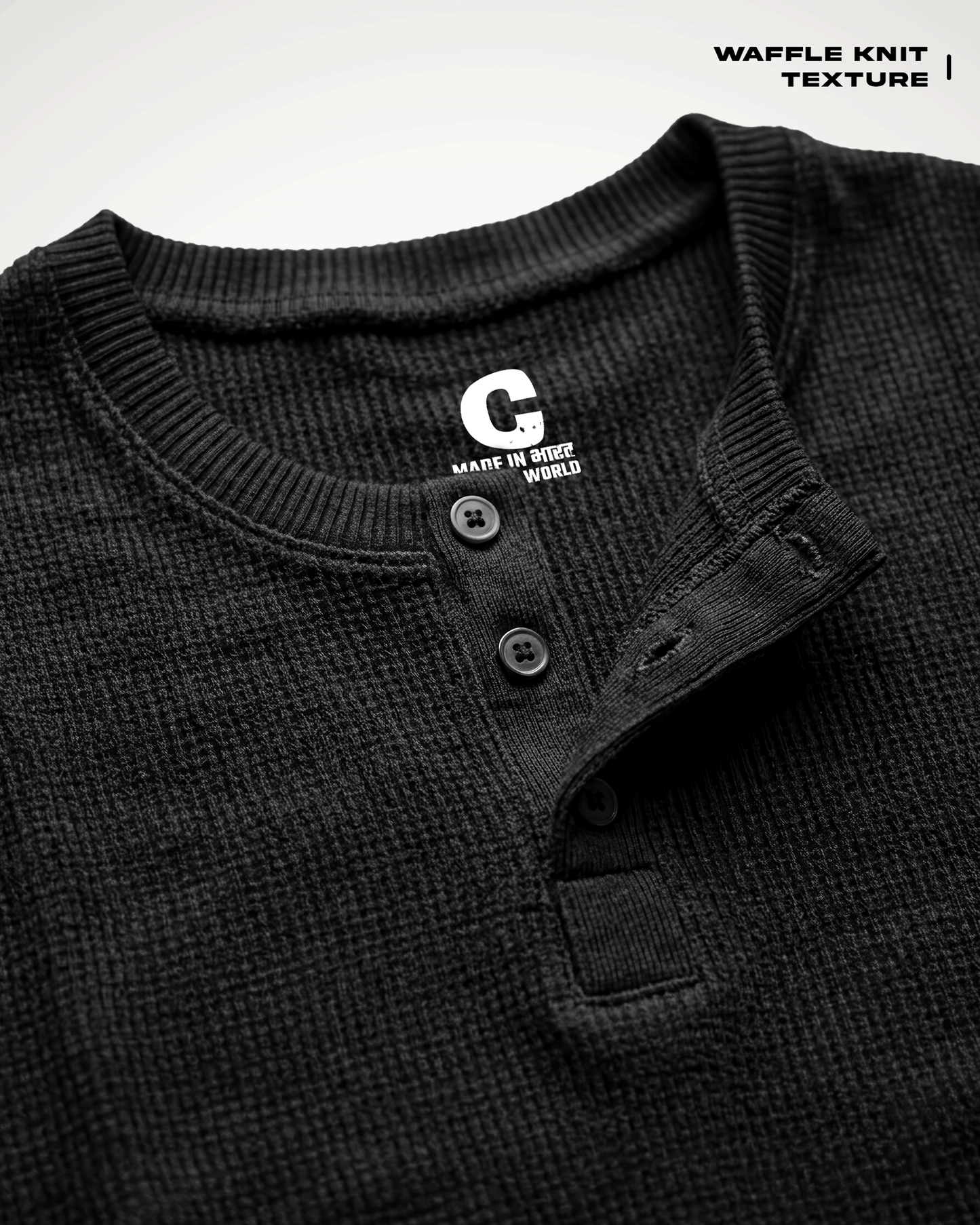 Close-up of a Waffle Knit Henley Full Sleeve T-shirt with a button placket and ribbed collar, showing a white 'G' logo on the inside neck label. Text in the top right reads 'WAFFLE KNIT TEXTURE'.