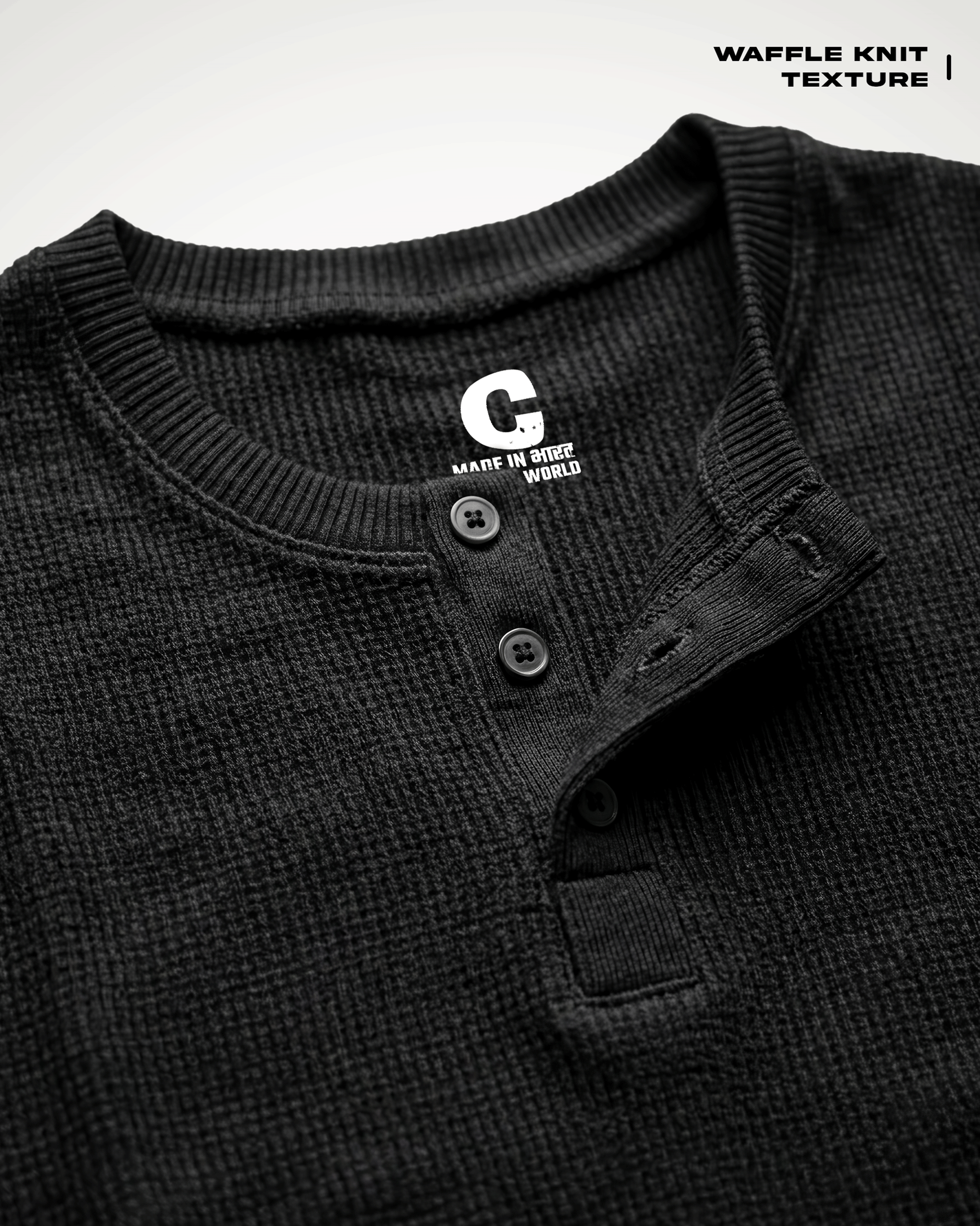 Close-up of a Waffle Knit Henley Full Sleeve T-shirt with a button placket and ribbed collar, showing a white 'G' logo on the inside neck label. Text in the top right reads 'WAFFLE KNIT TEXTURE'.